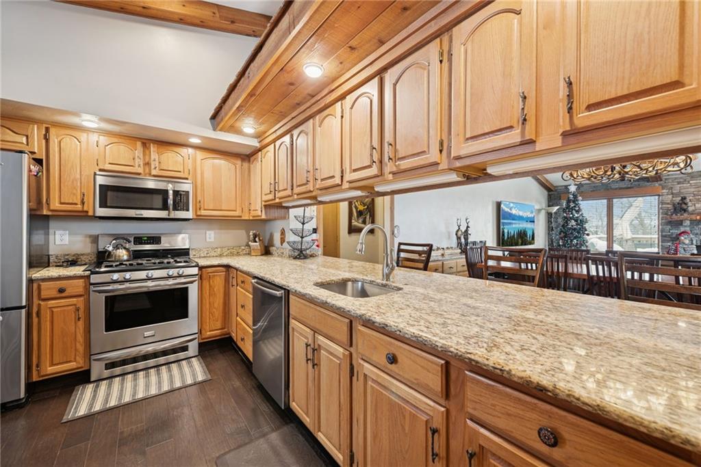 5228 Summit View Hidden Valley, PA 15502 - Photo 11 of 40 a kitchen with stainless steel appliances granite countertop a stove and a sink