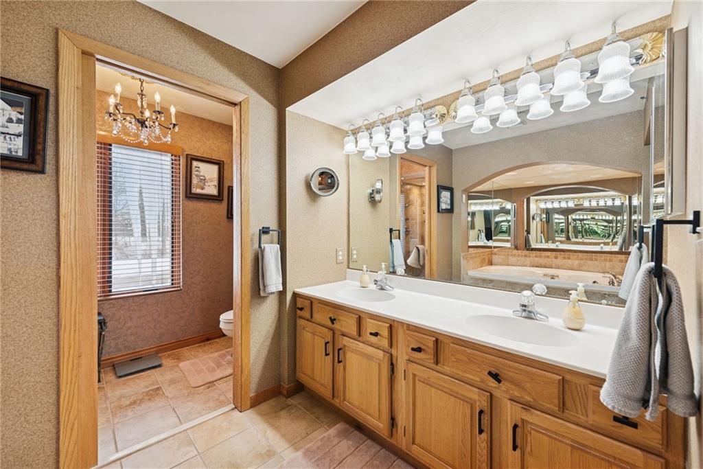 5228 Summit View Hidden Valley, PA 15502 - Photo 17 of 40 a spacious bathroom with a double vanity sink a mirror a and a shower