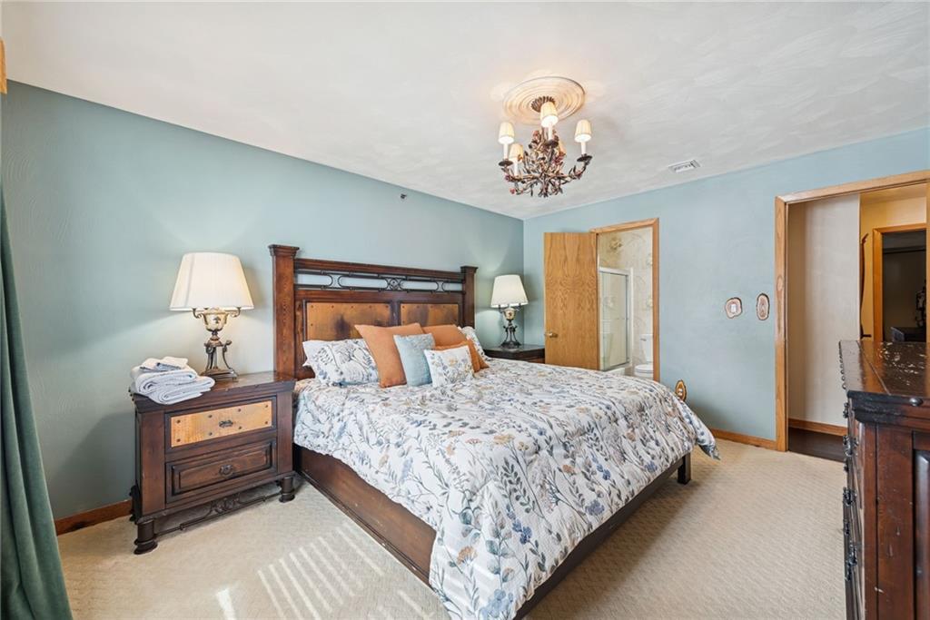 5228 Summit View Hidden Valley, PA 15502 - Photo 21 of 40 a bedroom with a bed and a chandelier