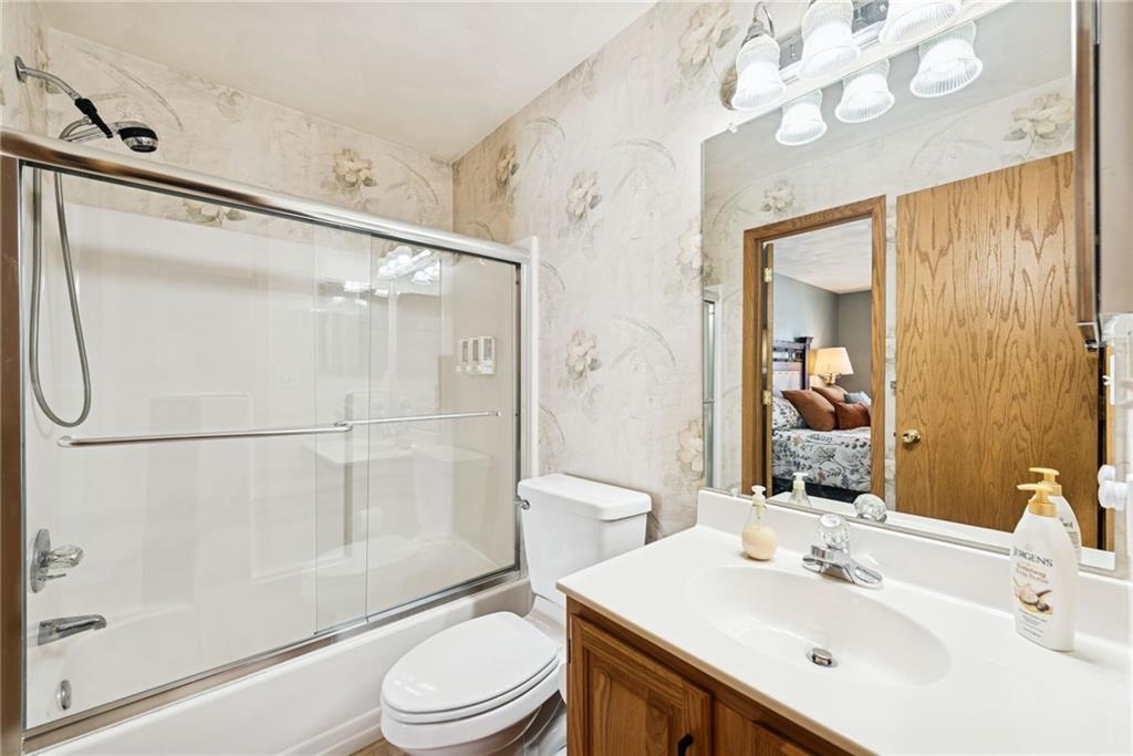 5228 Summit View Hidden Valley, PA 15502 - Photo 22 of 40 a bathroom with a sink a mirror a toilet and shower