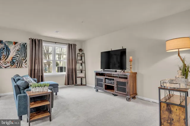 a bedroom with furniture and a flat screen tv