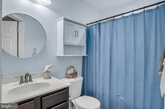 a bathroom with a sink toilet and mirror