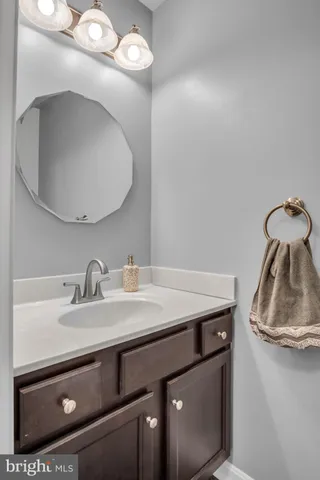 a sink with a mirror and vanity