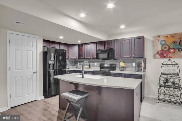 a kitchen with stainless steel appliances granite countertop a refrigerator sink and cabinets