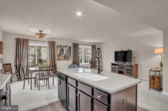 a kitchen with kitchen island a large counter space and stainless steel appliances