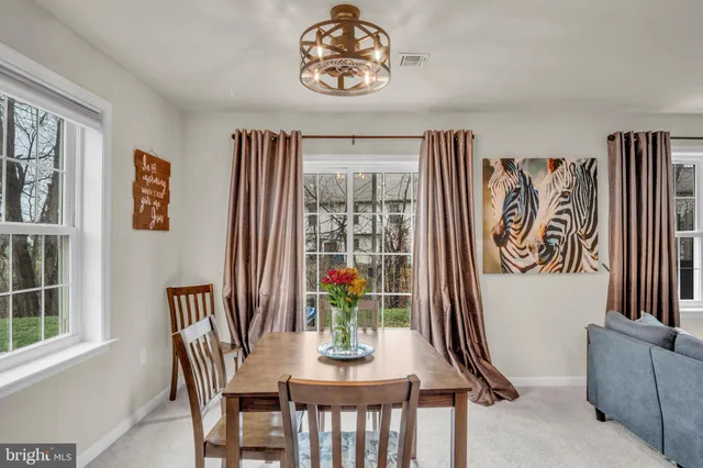 a dining room with furniture and window