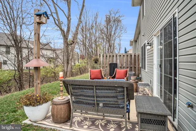 a view of a wooden chairs and table in the back yard