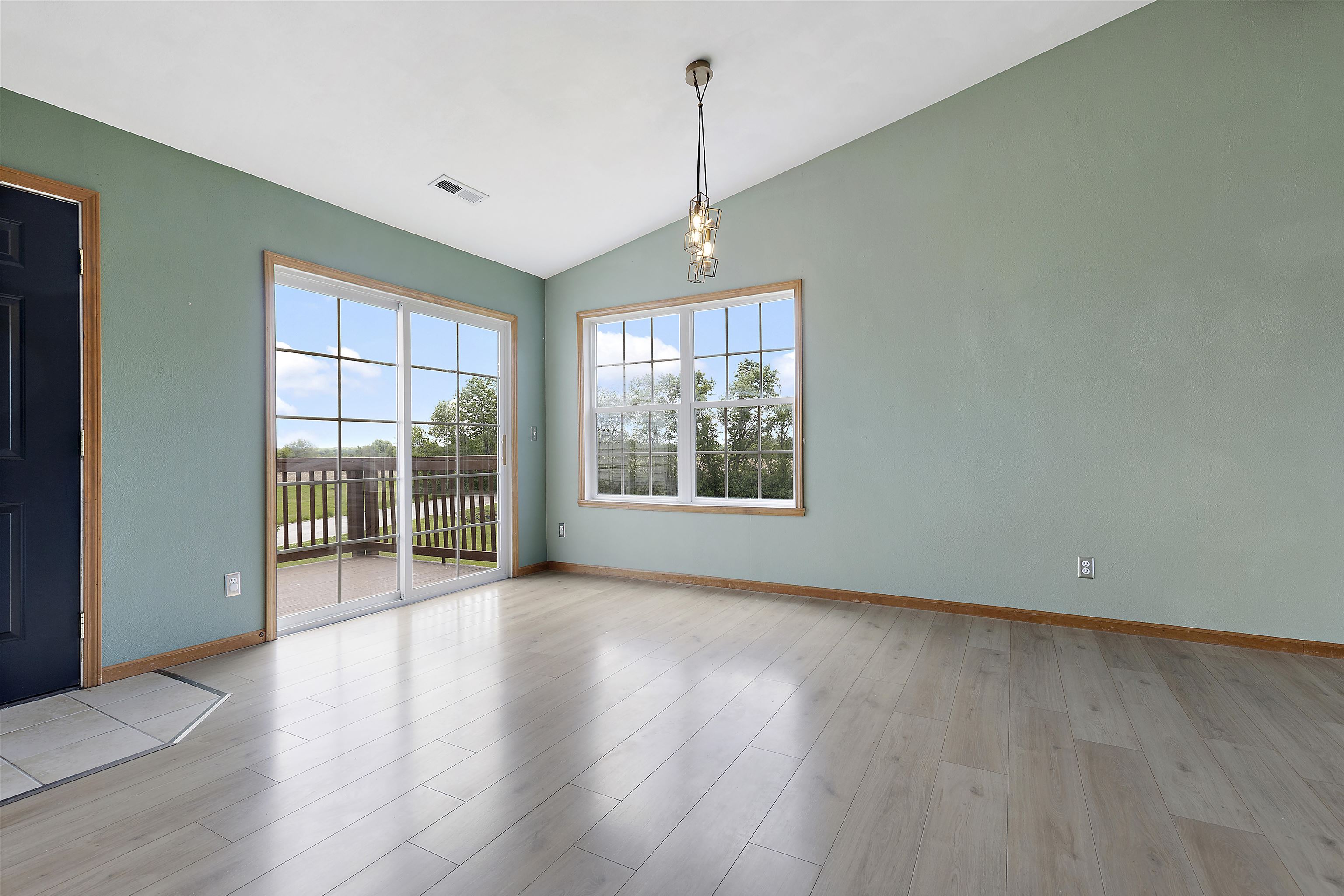 10050 Skipperling Road Roscoe, IL 61073 - Photo 3 of 15 an empty room with wooden floor and windows