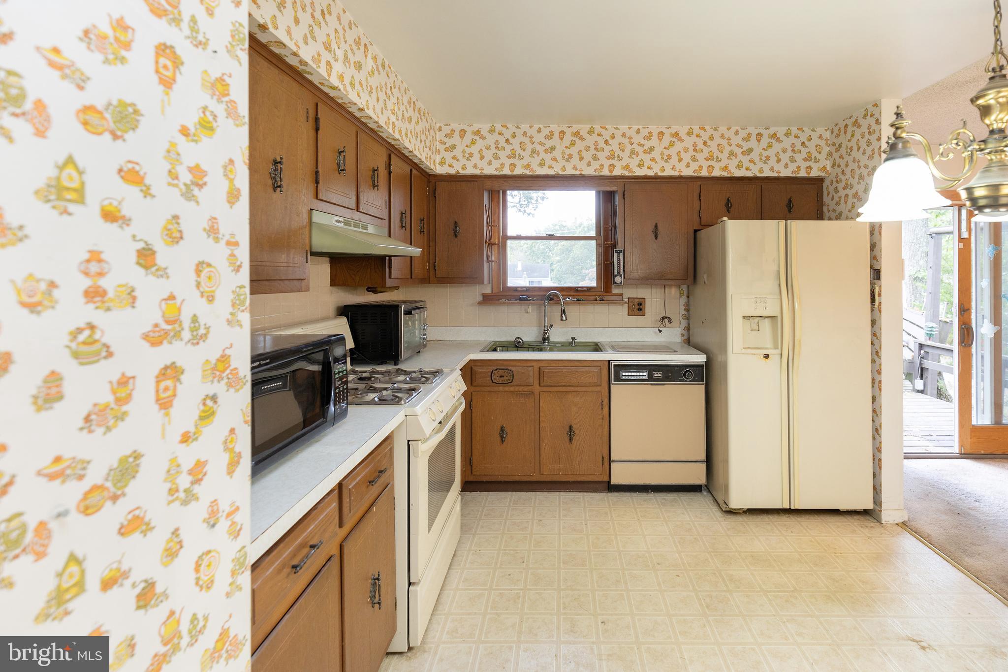 78 Diamond Avenue Pine Hill, NJ 08021 - Photo 19 of 36 a kitchen with a white stove refrigerator and cabinets