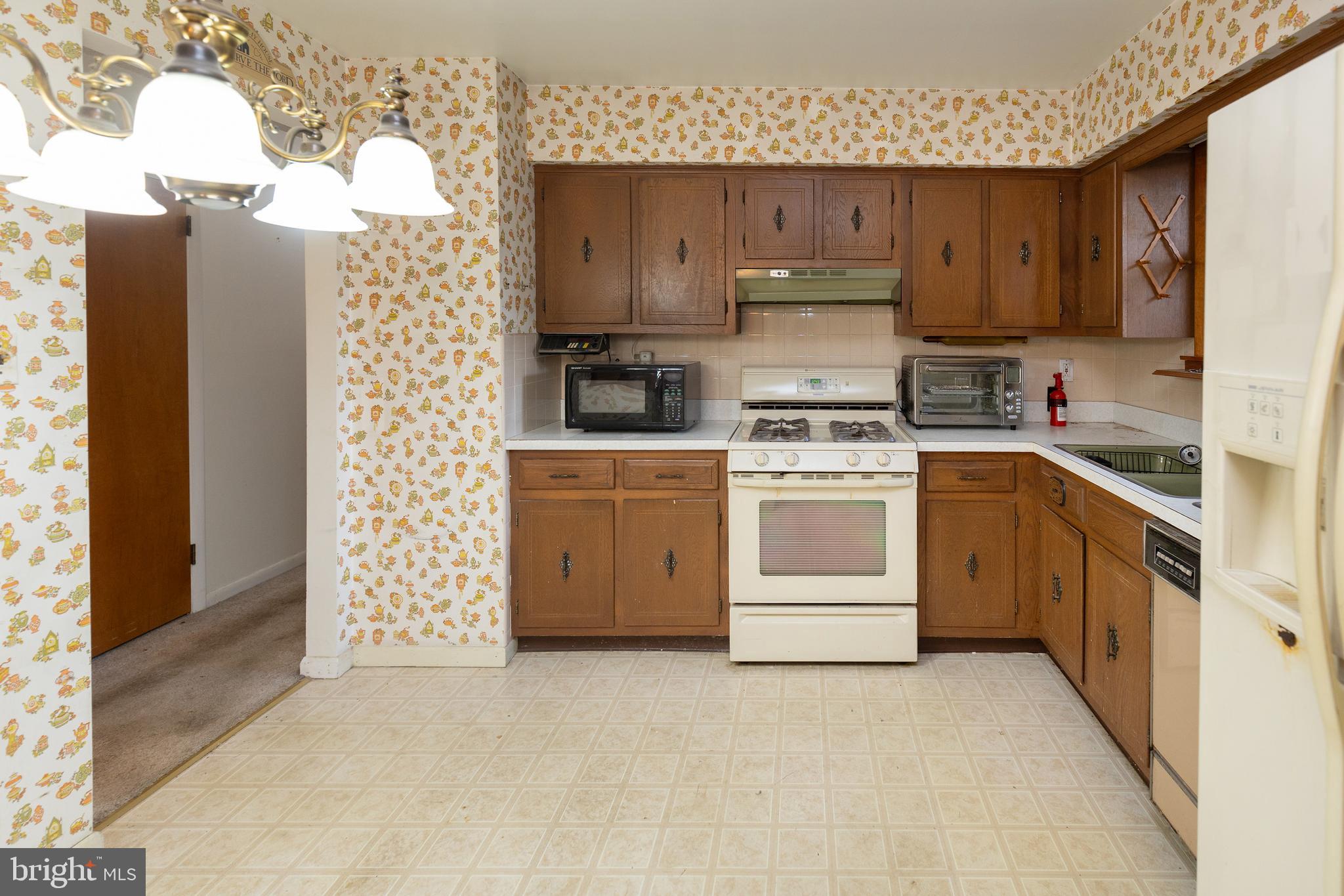 78 Diamond Avenue Pine Hill, NJ 08021 - Photo 20 of 36 a kitchen with cabinets appliances and a counter