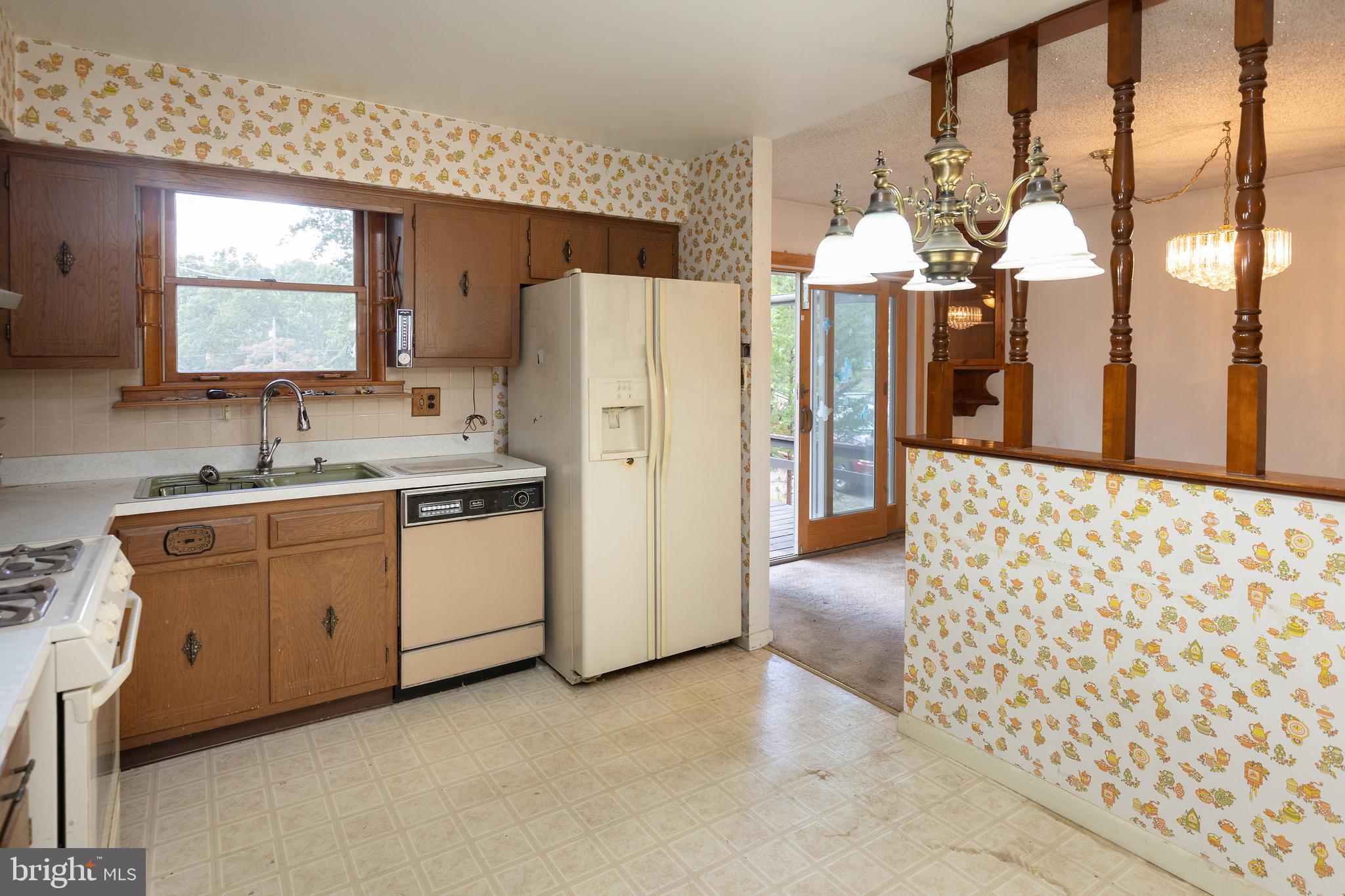 78 Diamond Avenue Pine Hill, NJ 08021 - Photo 23 of 36 a kitchen with a refrigerator sink and cabinets