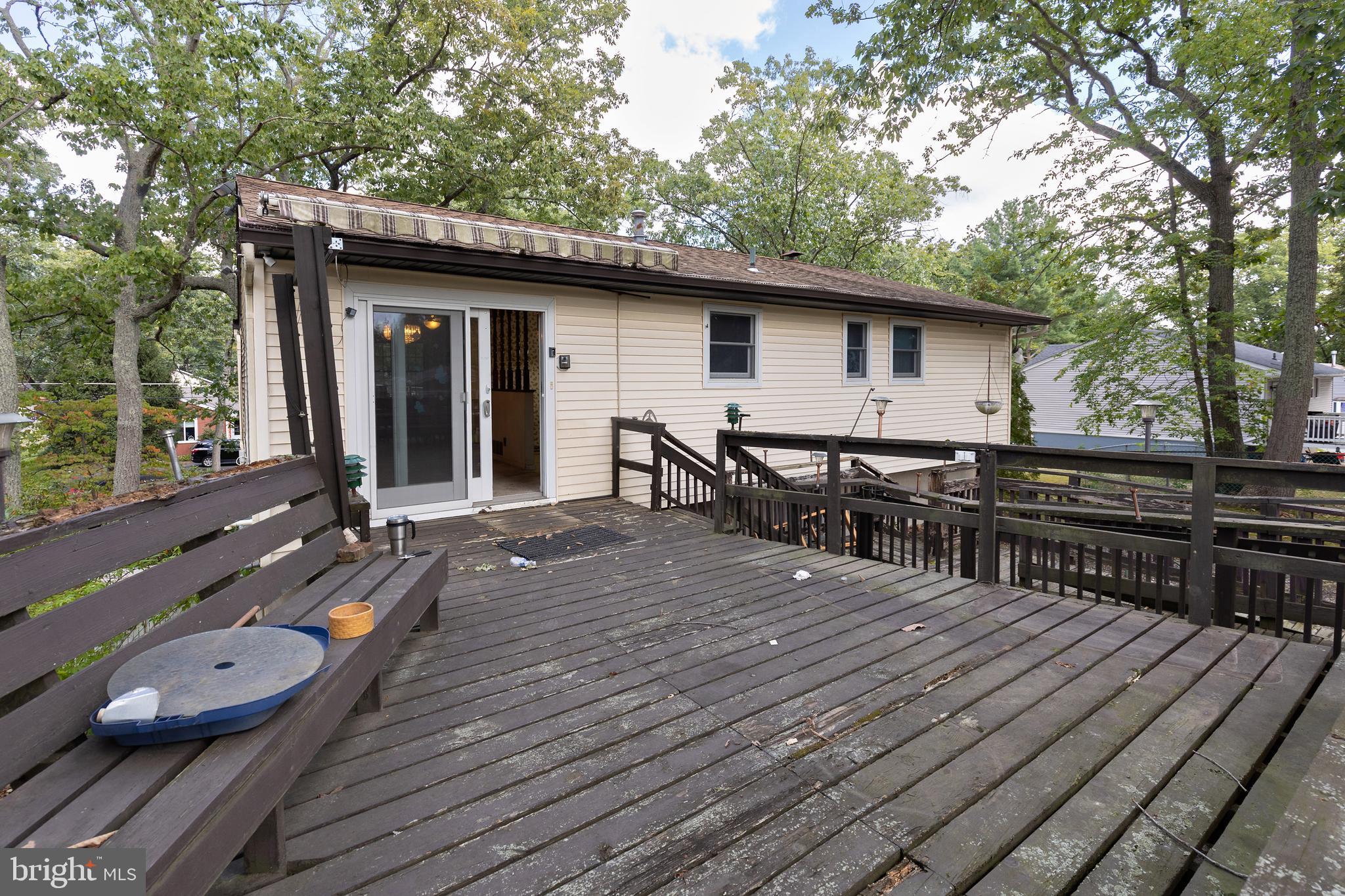 78 Diamond Avenue Pine Hill, NJ 08021 - Photo 4 of 36 a view of a wooden deck and a patio with table and chairs a barbeque with wooden floor and fence