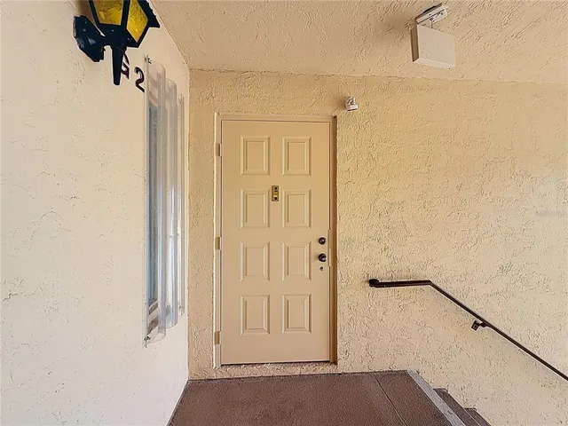 a kitchen with granite countertop a refrigerator and a stove top oven