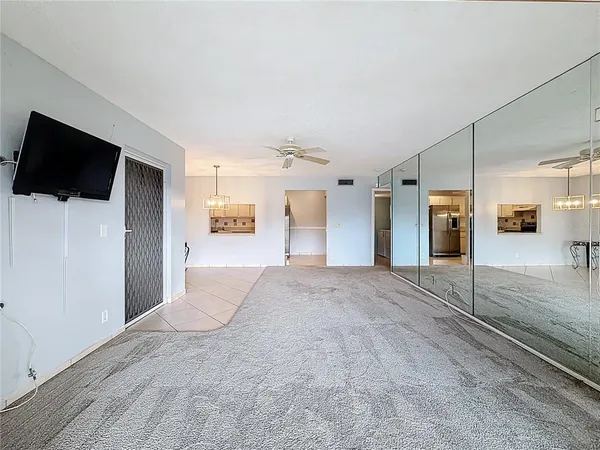 a kitchen with white cabinets and appliances