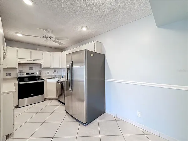 an aerial view of a house with a garden and lake view