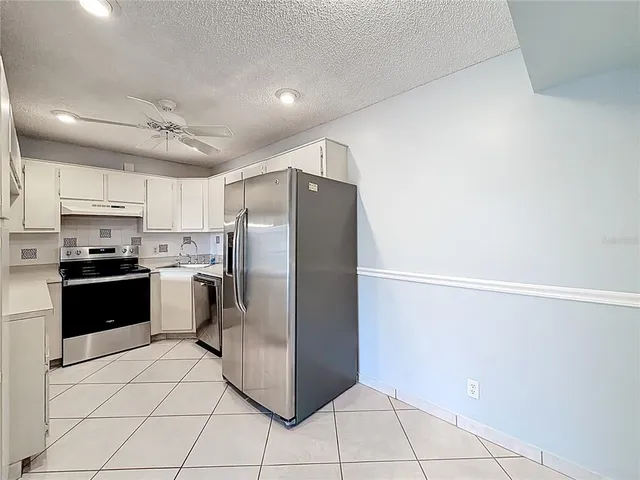 an aerial view of a house with a garden and lake view