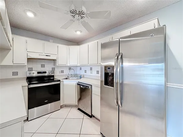an aerial view of residential houses with yard and ocean view
