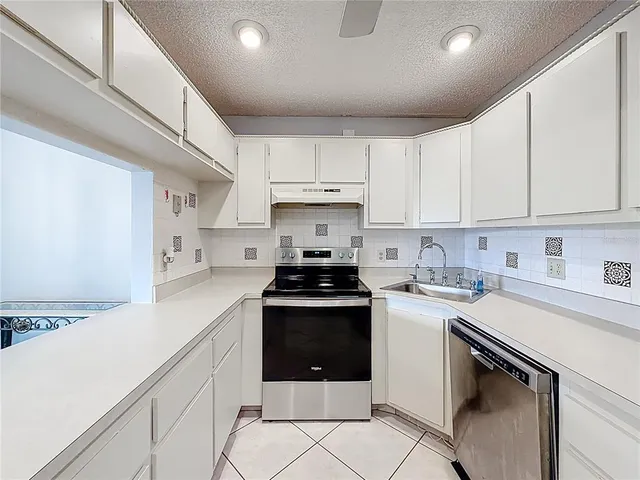 an aerial view of a city with a lake view