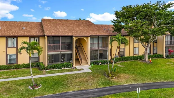 a view of a big house with a big yard and potted plants