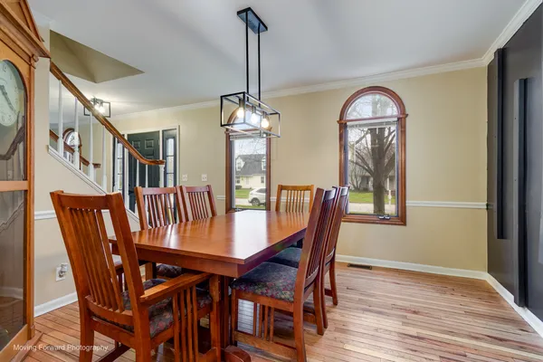 a view of a dining room with furniture window and wooden floor