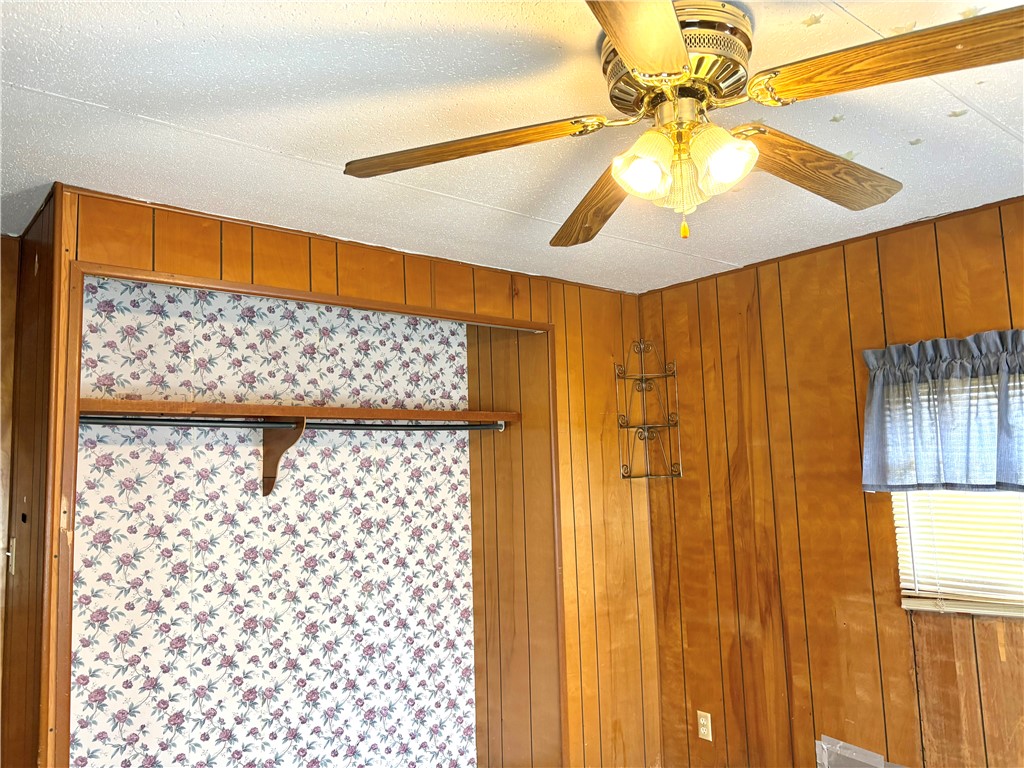5434 North Waynesville Road, Unit 15 Oregonia, OH 45054 - Photo 2 of 19 This cozy bedroom features warm wood paneling and a practical built-in closet.