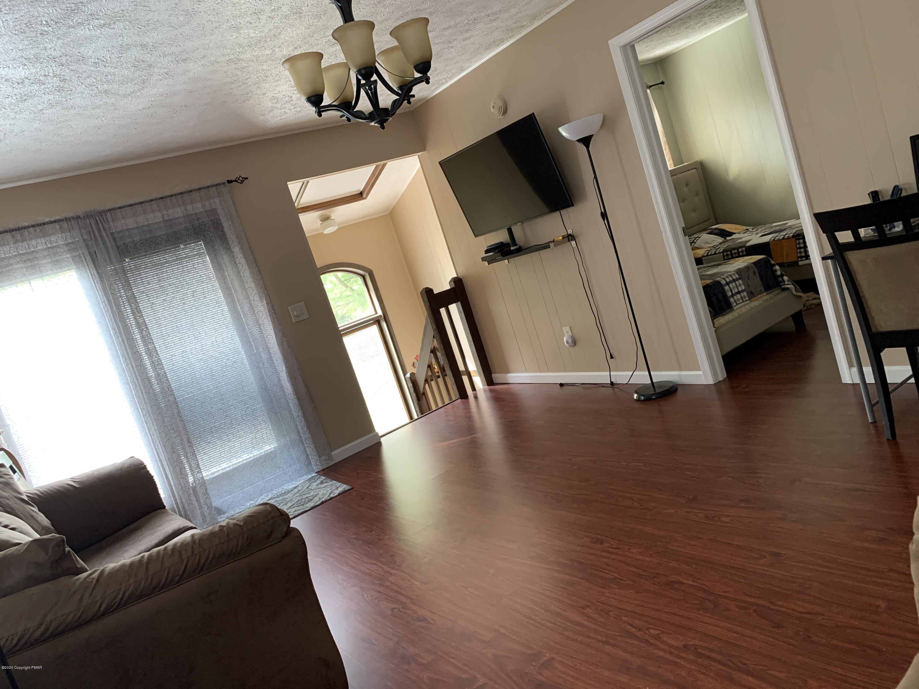 370 Canterbury Road Bushkill, PA 18324 - Photo 23 of 50 a view of a livingroom with furniture wooden floor and windows