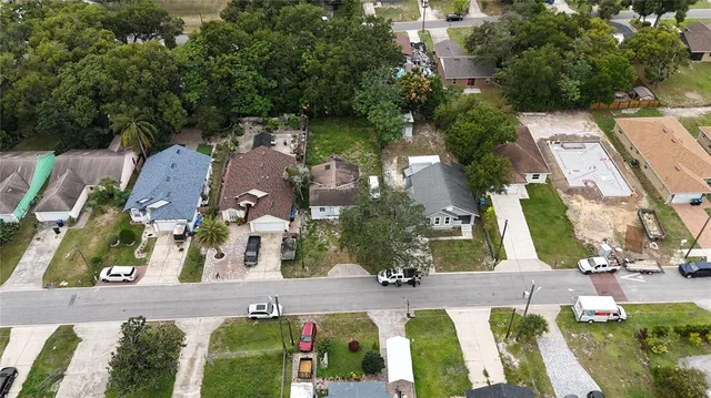 an aerial view of multiple houses with yard