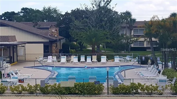 a view of a house with swimming pool and sitting area