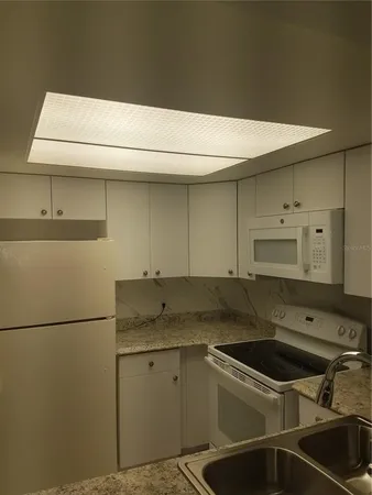 a sink sitting inside of a kitchen
