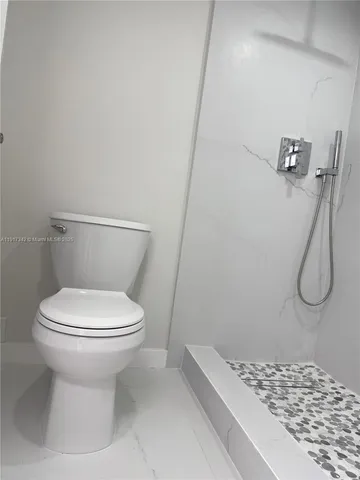 a white toilet sitting next to a bathroom sink