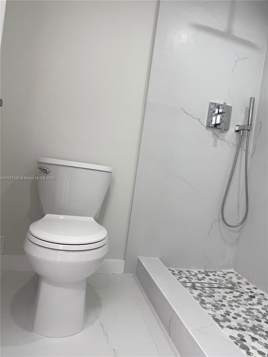 210 174th Street, Unit 1804 Sunny Isles Beach, FL 33160 - Photo 11 of 31 a bathroom with a toilet and a shower