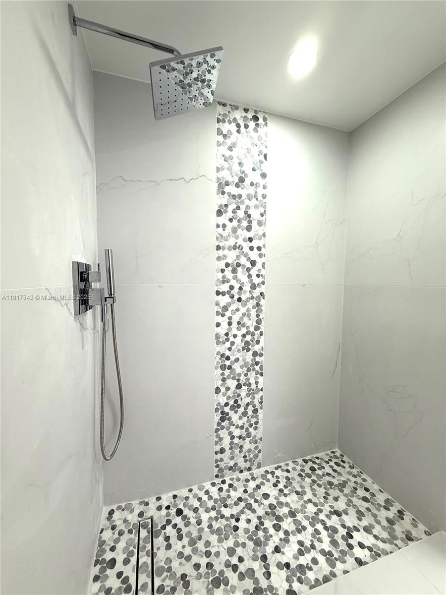 210 174th Street, Unit 1804 Sunny Isles Beach, FL 33160 - Photo 14 of 31 a bathroom with a shower