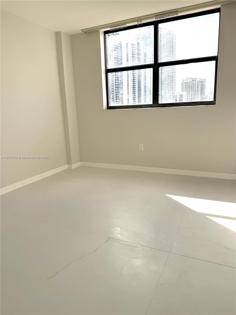 210 174th Street, Unit 1804 Sunny Isles Beach, FL 33160 - Photo 15 of 31 a view of an empty room with a window