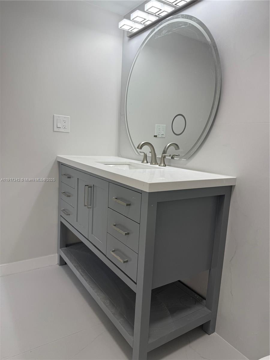 210 174th Street, Unit 1804 Sunny Isles Beach, FL 33160 - Photo 19 of 31 a bathroom with a sink and a mirror