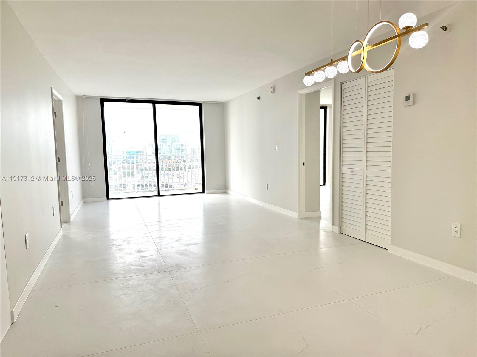 210 174th Street, Unit 1804 Sunny Isles Beach, FL 33160 - Photo 2 of 31 a view of an empty room with a window