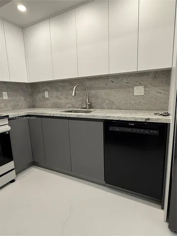 a kitchen with stainless steel appliances granite countertop a refrigerator a stove and a sink with wooden floor