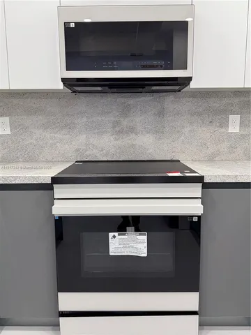 a kitchen with storage and utility