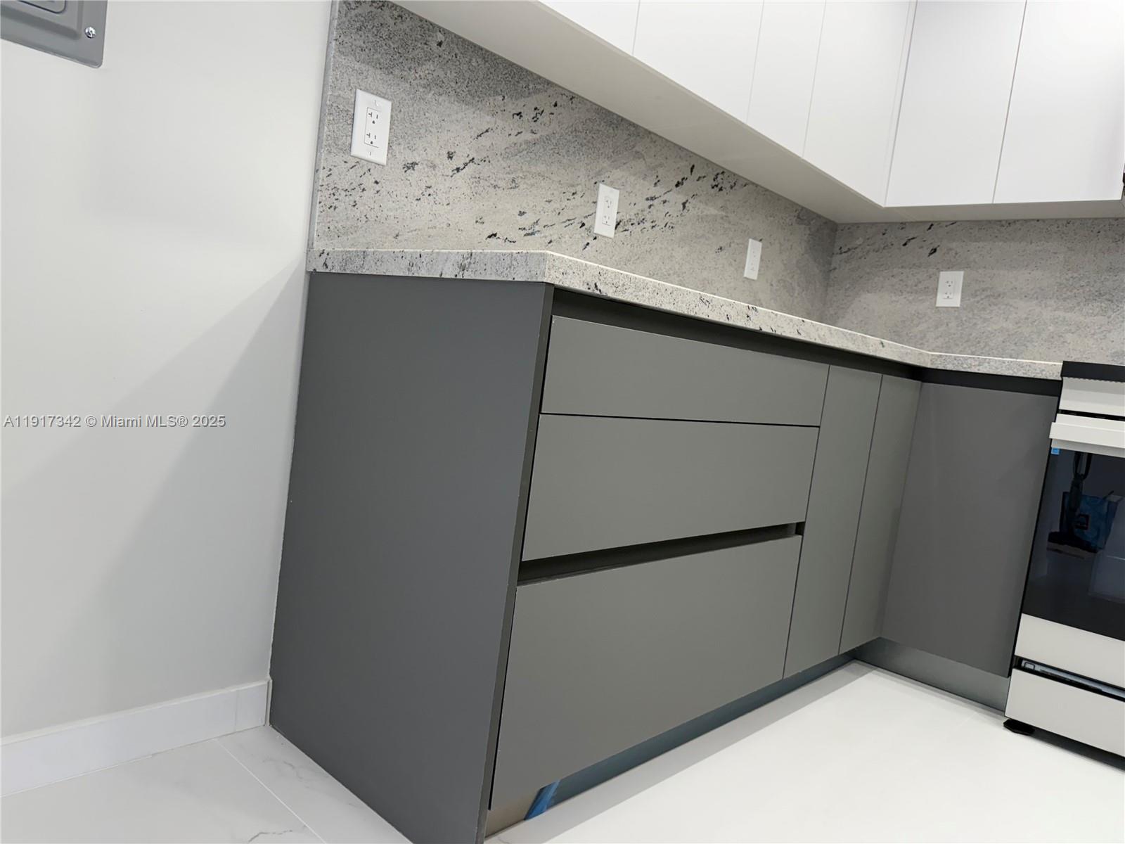 210 174th Street, Unit 1804 Sunny Isles Beach, FL 33160 - Photo 29 of 31 a kitchen with storage and utility