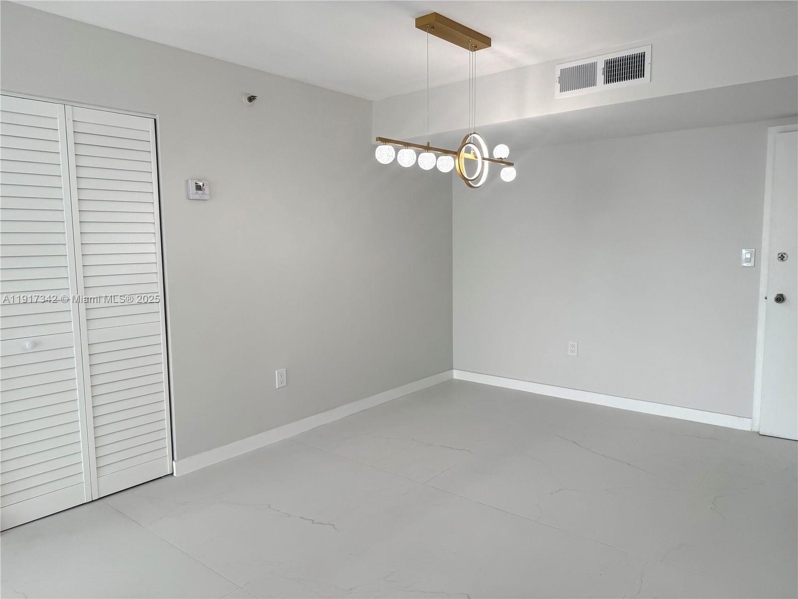 210 174th Street, Unit 1804 Sunny Isles Beach, FL 33160 - Photo 3 of 31 wooden floor in an empty room