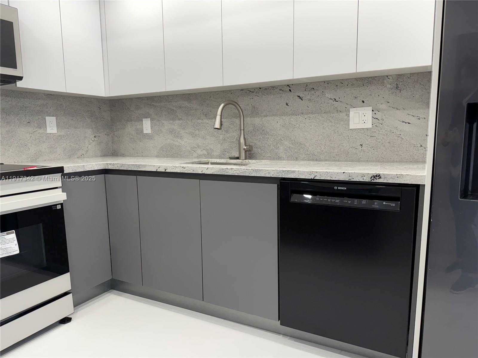 210 174th Street, Unit 1804 Sunny Isles Beach, FL 33160 - Photo 31 of 31 a kitchen with a sink and cabinets