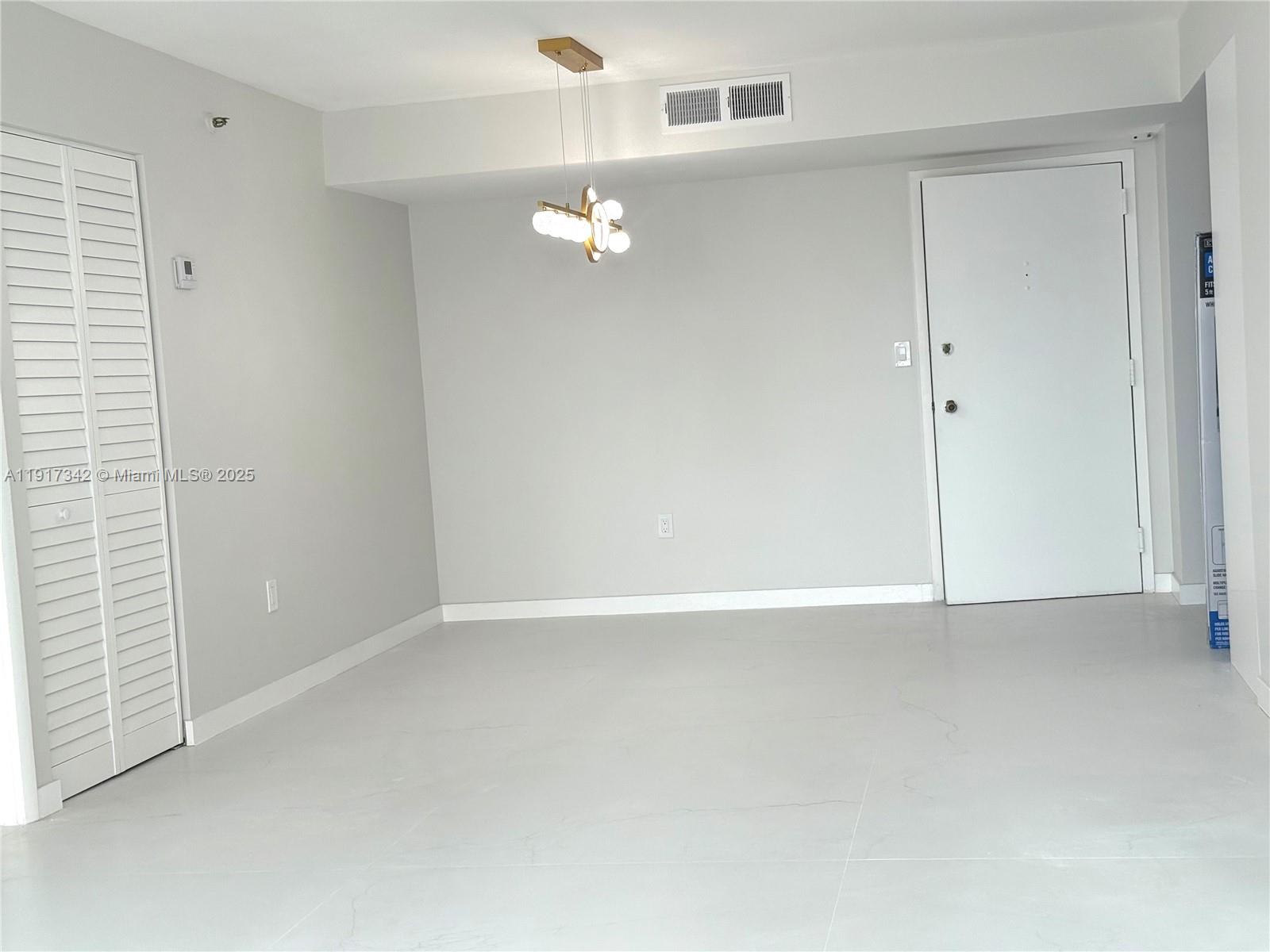210 174th Street, Unit 1804 Sunny Isles Beach, FL 33160 - Photo 4 of 31 a view of an empty room with a window