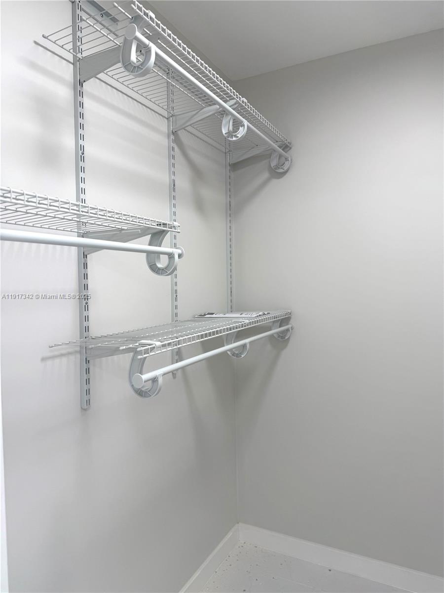 210 174th Street, Unit 1804 Sunny Isles Beach, FL 33160 - Photo 9 of 31 a view of a room with racks on the wall