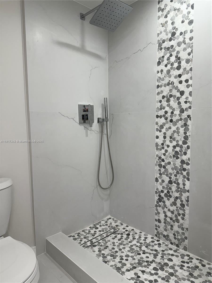 210 174th Street, Unit 1804 Sunny Isles Beach, FL 33160 - Photo 10 of 31 a bathroom with a shower toilet and a sink