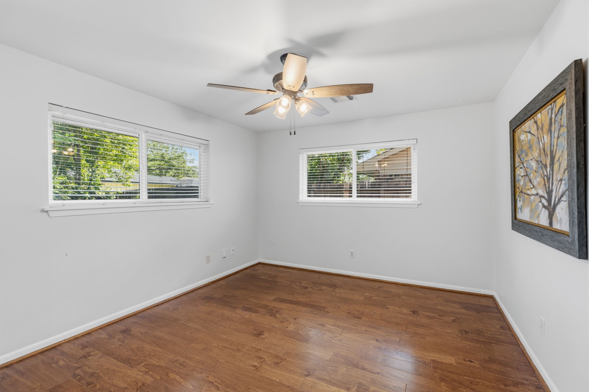 5410 Indigo Street Houston, TX 77096 - Photo 15 of 30 Large primary bedroom has nice double pane windows, new ceiling fan, fresh paint and gleaming floors.