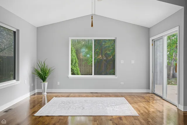 a view of an entryway with a floor to ceiling window and potted plants