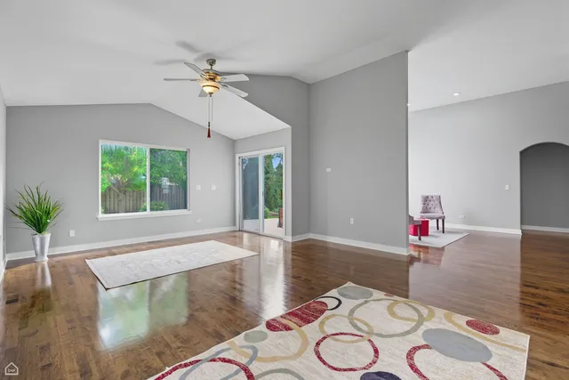 a living room with dining table and wooden floor