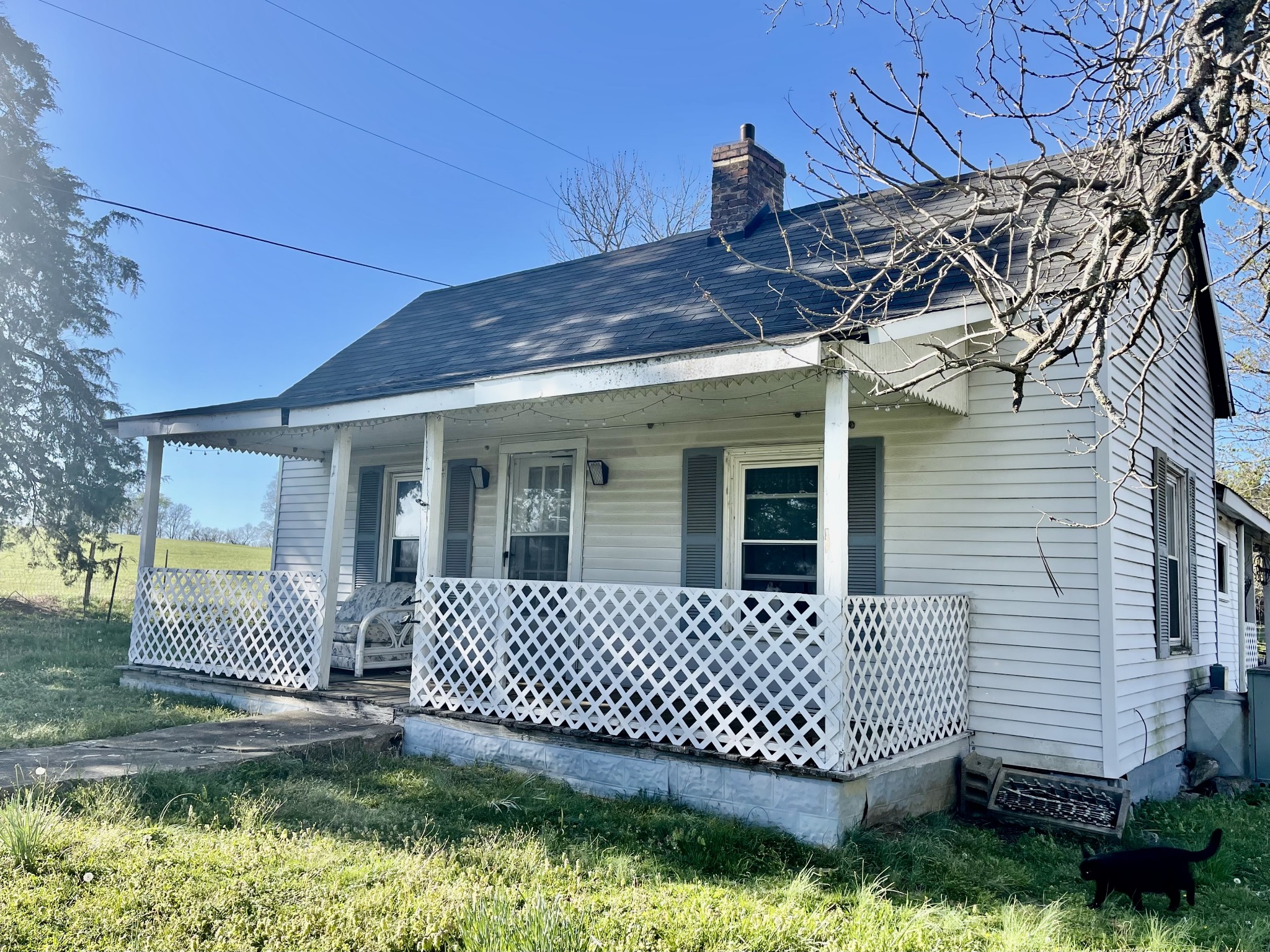 a view of a house with a yard and deck