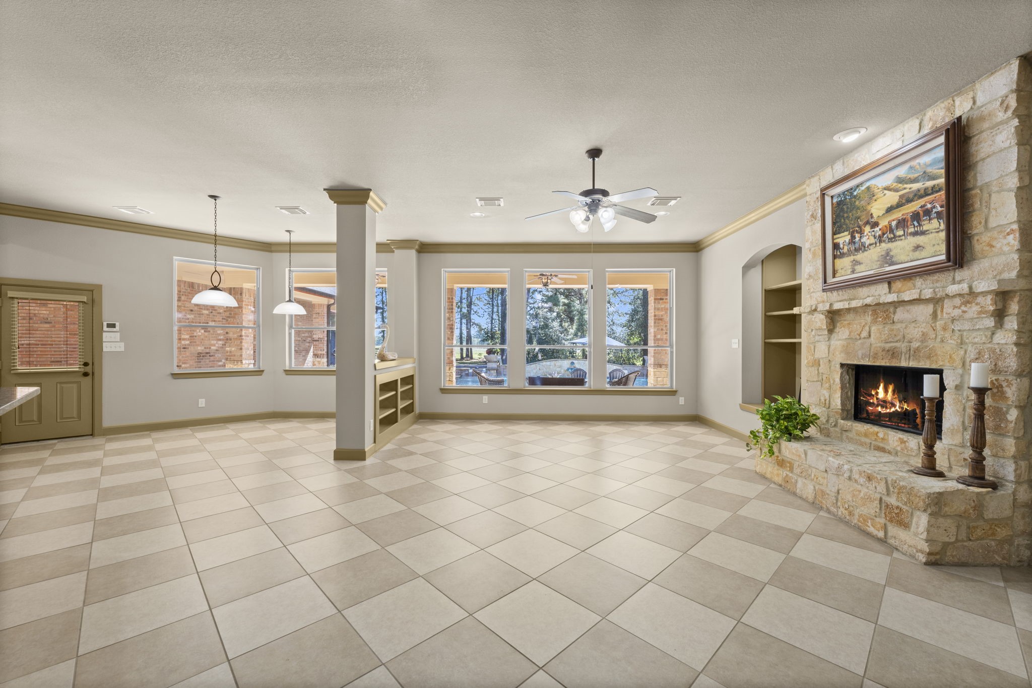 1534 Virgie Community Road Magnolia, TX 77354 - Photo 17 of 50 The relaxing living area is centered around a warm, inviting fireplace, and large windows offering a beautiful view of the backyard oasis.