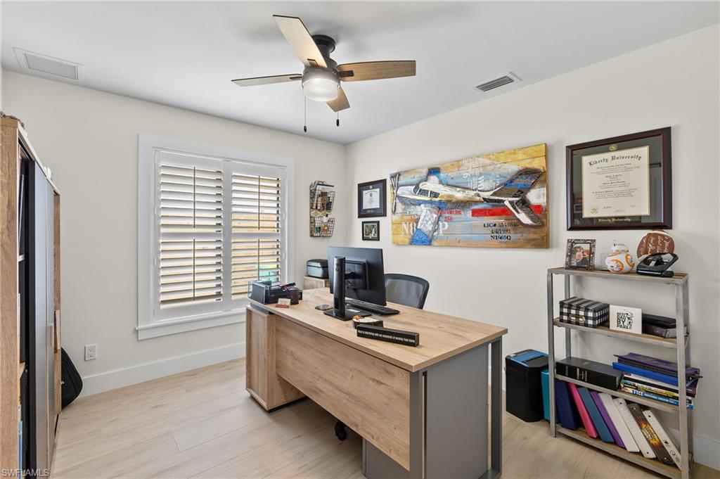 10274 Boca Circle Naples, FL 34109 - Photo 19 of 26 a view of a workspace with furniture and a window