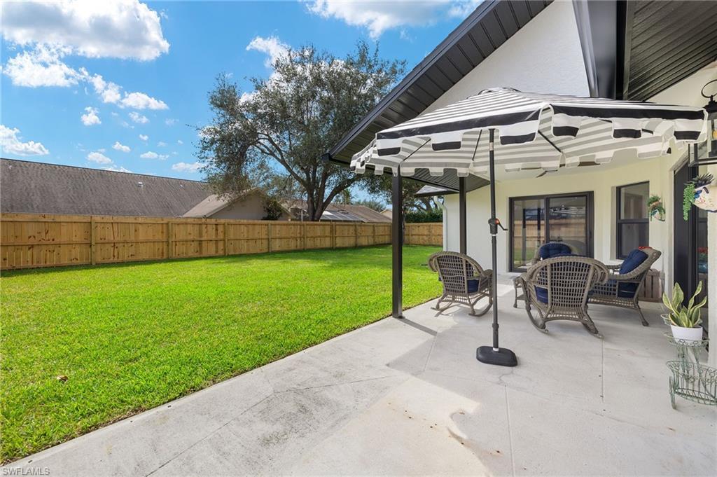10274 Boca Circle Naples, FL 34109 - Photo 21 of 26 a view of a patio with a table and chairs